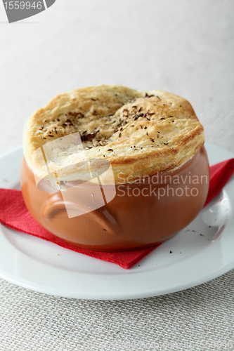 Image of pancake on brown pot