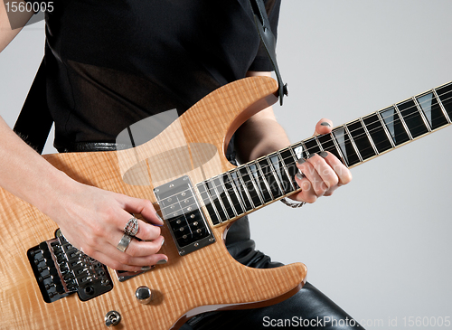 Image of Female guitarist playing electric guitar