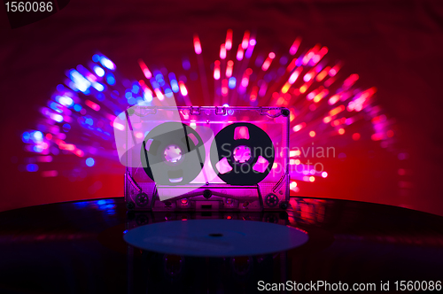 Image of LP vinyl record, cassette tape and disco lights