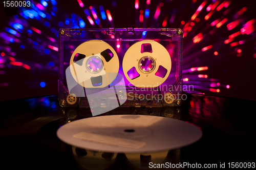 Image of LP vinyl record, cassette tape and disco lights