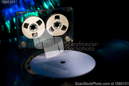 Image of LP vinyl record, cassette tape and disco lights