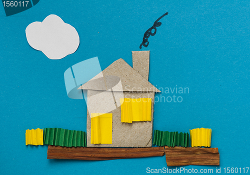 Image of House made â€‹â€‹of paper over blue paper