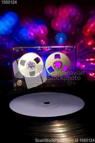 Image of LP vinyl record, cassette tape and disco lights