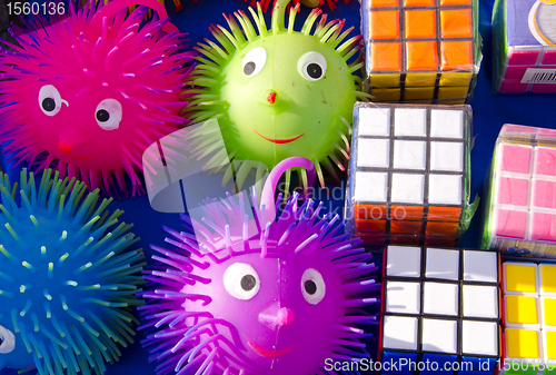 Image of Rubik and rubber toys smile sold in outdoor fair. 