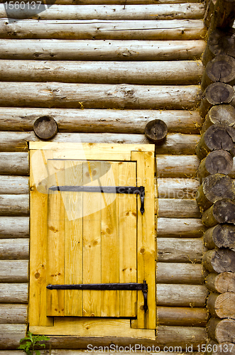 Image of Old log house background new wooden door of board 