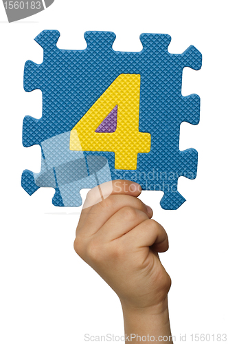 Image of Children hand holding the number Four. White isolated number
