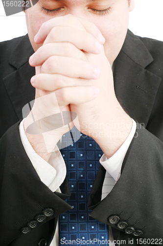 Image of portrait of businessman praying for success