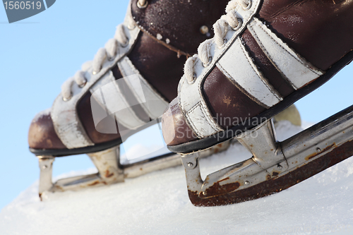 Image of vintage pair of mens  skates on the ice