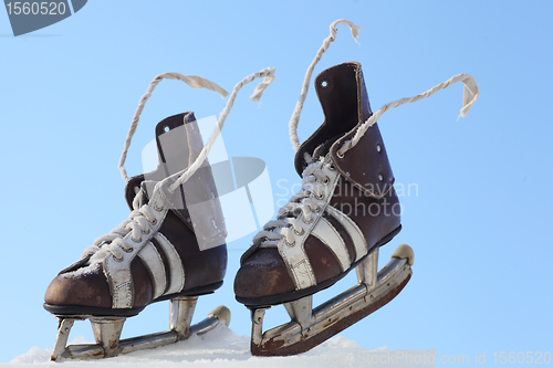 Image of vintage pair of mens  skates on the ice