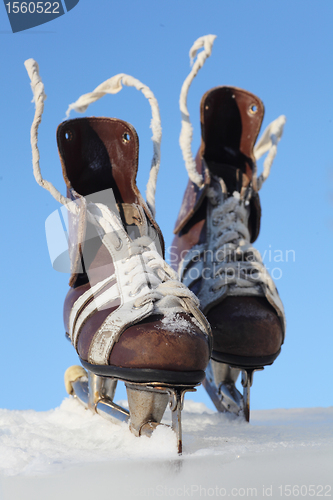 Image of vintage pair of mens  skates on the ice