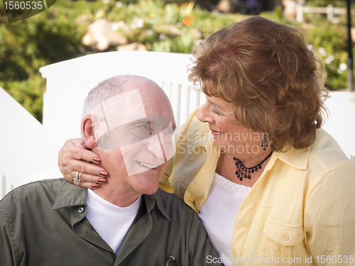 Image of Senior Couple Kissing in the Park
