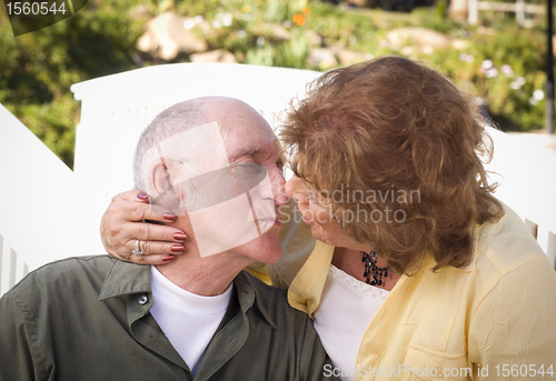 Image of Senior Couple Kissing in the Park