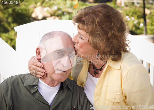 Image of Senior Couple Kissing in the Park