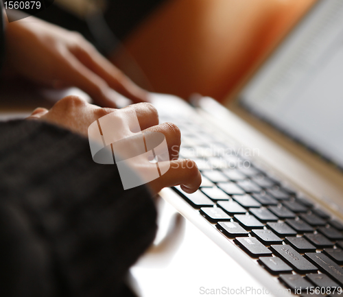 Image of Young woman working on laptop