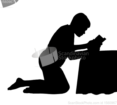 Image of Child Reading Bible next to Bed