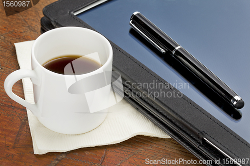 Image of tablet computer, stylus and coffee