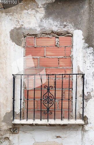 Image of Old balcony door blocked by brick wall