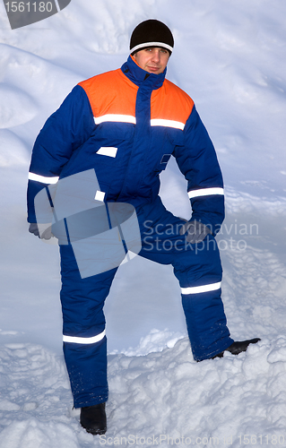 Image of An employee in a warm suit on the street. Much snow