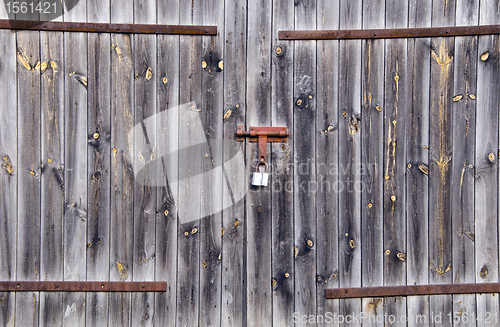 Image of Old wooden farm rural building door locked padlock 