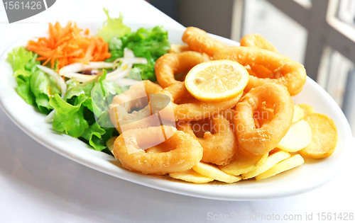 Image of Deep batter fried squid rings calamari with green salad 