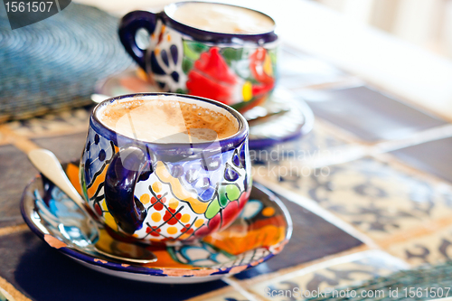 Image of Cappuccino served in colorful cups