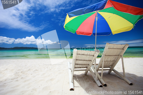 Image of Two beach chairs and colorful umbrella