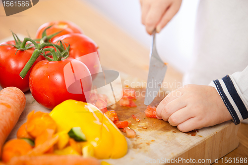 Image of Child making salad