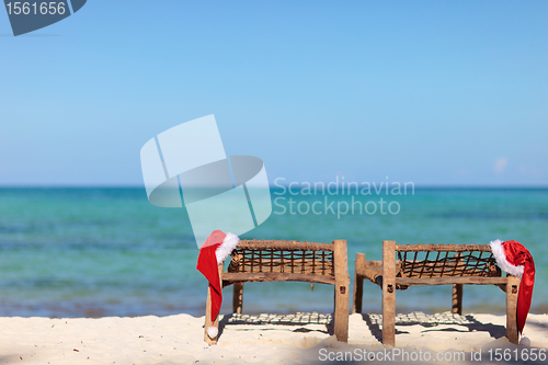 Image of Two santa hats on sunbeds