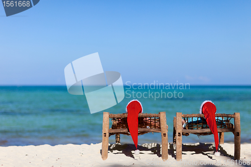 Image of Couple in Santa hats on tropical beach