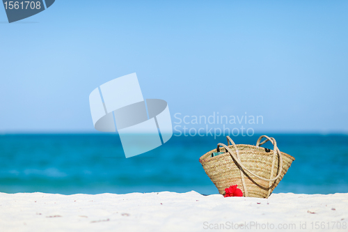 Image of Straw beach bag on exotic white sand beach