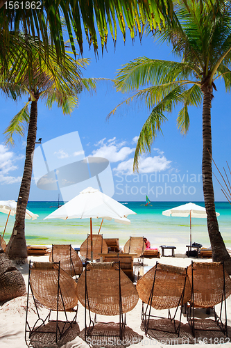 Image of Wooden beach chairs on exotic beach