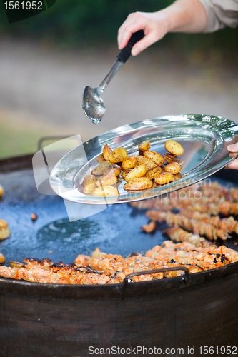 Image of Chef cooking for a group