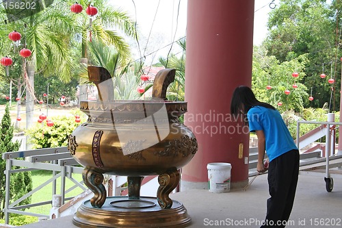 Image of Girl praying in Chinese temple