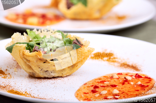 Image of Fresh light salad in parmesan cheese basket