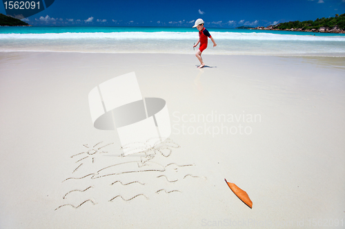 Image of Tropical island drawing on sand