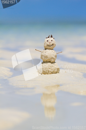 Image of Snowman made from sand on beach