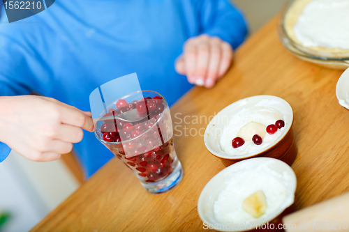 Image of Boy baking cupcakes closeup