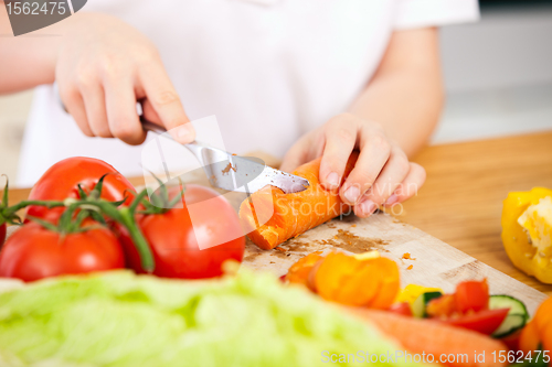 Image of Child making salad