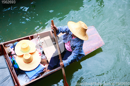 Image of Vendor on traditional floating market in Thailand