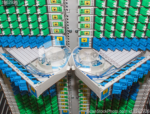 Image of fiber optic rack with high density of blue and green SC connectors