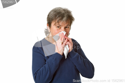 Image of Senior woman blowing her nose 