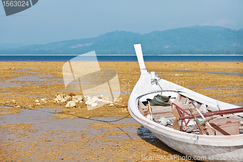 Image of Thai fishing wooden boat on the coast