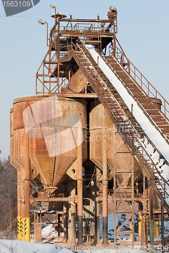 Image of Belt conveyors and silos in a gravel pit in winter