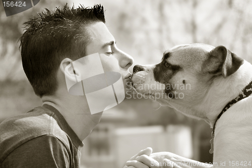 Image of Boy kissing his dog