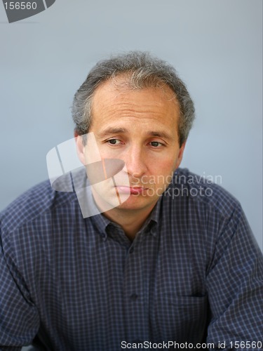 Image of Unhappy businessman frowning