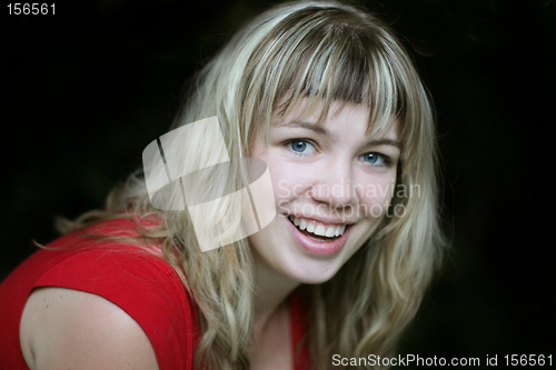 Image of Smiling blond girl in red