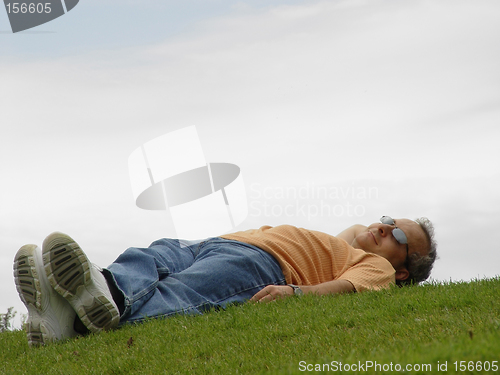 Image of A man lying on the grass