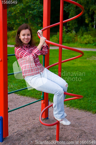 Image of happy young woman on playground