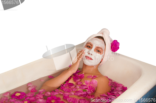 Image of beautiful woman enjoying floral bath