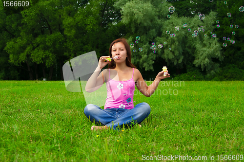 Image of girl blowing soap bubbles